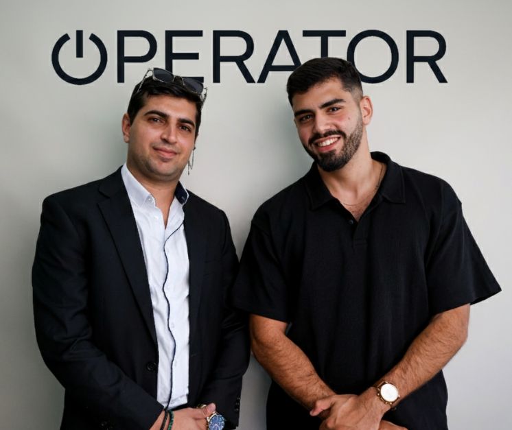 Two people standing in front of an Operator sign